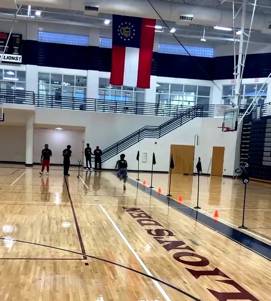 Athletes running a timed drill through cones at a Lockerroom testing event