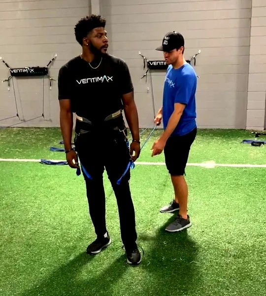 Athlete fitted with a Vertimax resistance harness before a training rep