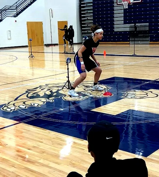 Athlete running a laser-timed agility drill
